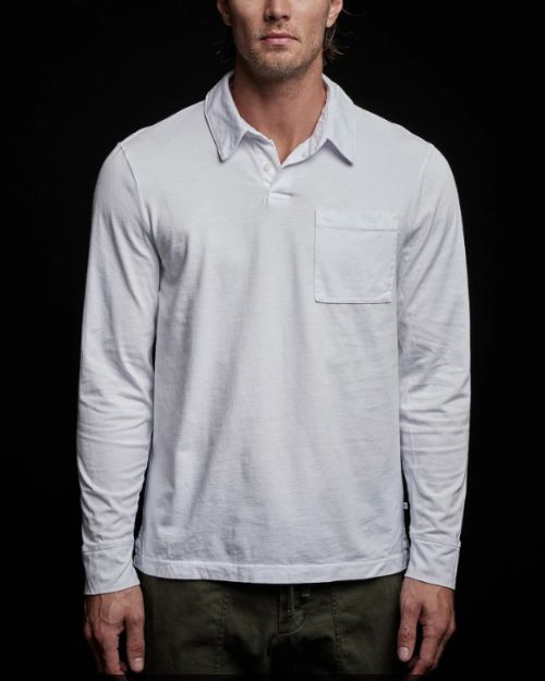 A man wearing a white cotton jersey rugby shirt with a pocket, standing against a neutral background.