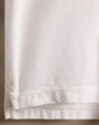 Close-up of a 100% white cotton jersey rugby shirt, showcasing its soft texture and classic design.