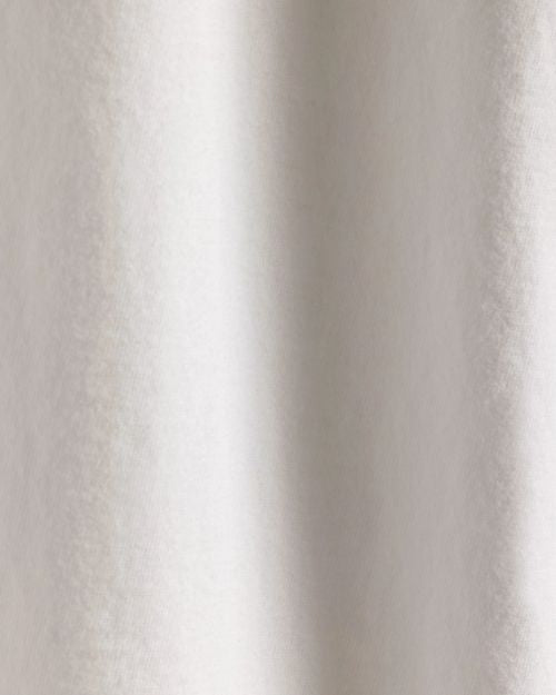 Close-up of a white cotton jersey rugby shirt on a white background, highlighting its texture and fabric details.
