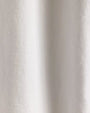 Close-up of a white cotton jersey rugby shirt on a white background, highlighting its texture and fabric details.