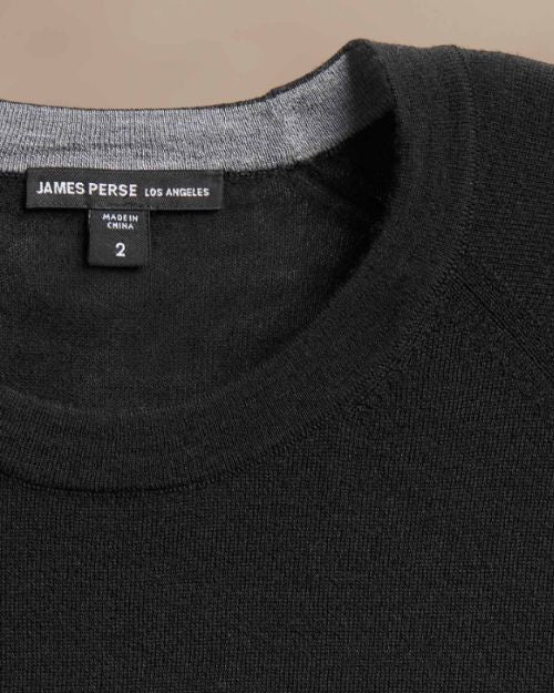  Ultra-fine black cashmere sweater displayed on a neutral background.
