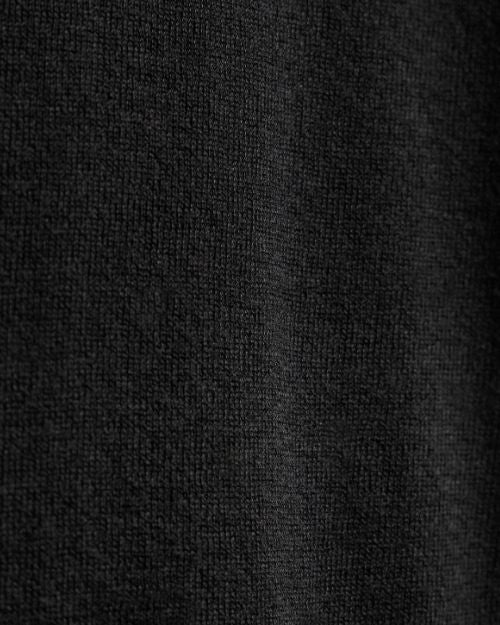 A close-up of an ultra-fine black cashmere sweater, showcasing its soft texture and elegant design.
