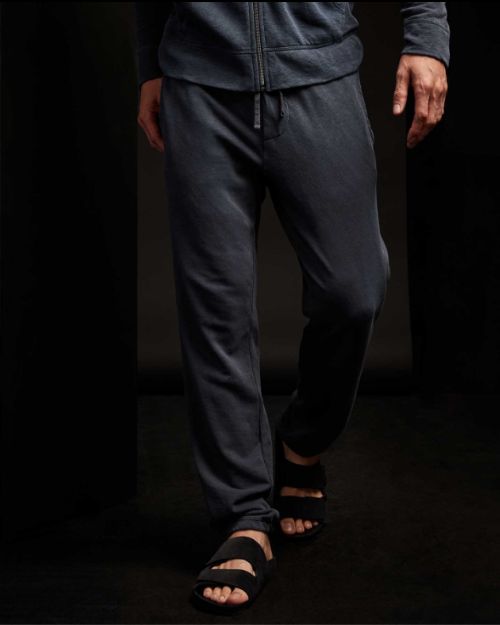 A man wearing a zip hoodie and sandals, paired with vintage French Terry sweatpants.
