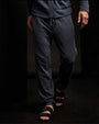 A man wearing a zip hoodie and sandals, paired with vintage French Terry sweatpants.
