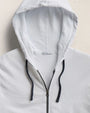 A white zip-up hoodie made from lightweight Supima cotton terry, showcasing a vintage French Terry design.
