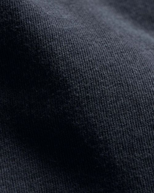 Close-up of a vintage zip-up hoodie, showcasing its fabric texture and design details.
