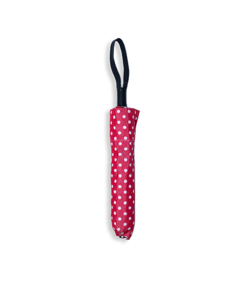 Red and white polka dot umbrella closed and wrapped up.