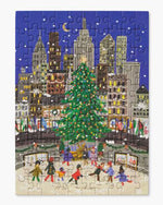 Box of a 100-piece mini puzzle shows a winter city scene with people skating under a large Christmas tree. 