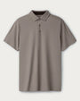 Light taupe short-sleeve polo shirt with a three-button placket and classic collar, displayed on a clean neutral background.