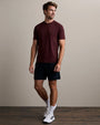 Men's burgundy athletic fit crew neck performance t-shirt paired with black training shorts
