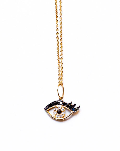 Small Eyelash Necklace in yellow gold with pave diamonds in white and black, necklace on a white background.