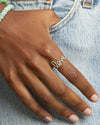 Hand model wearing love script ring.