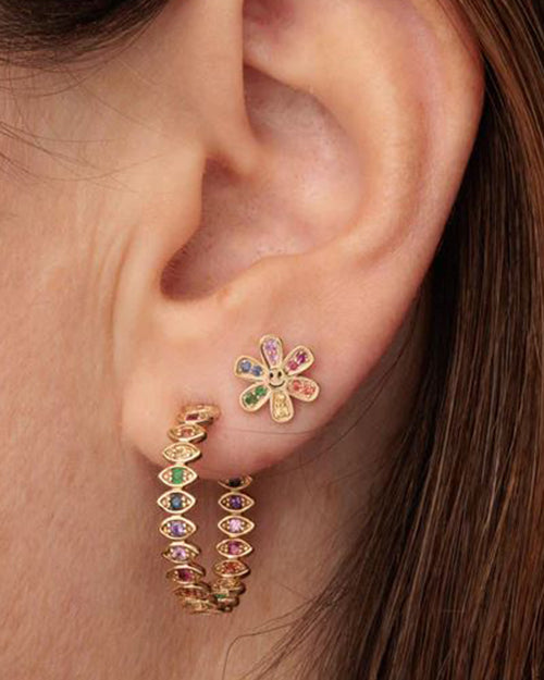 Model wearing medium marquise evil aye hoops with rainbow stones on each of the eyes, and a second earring with the same color stones to match.