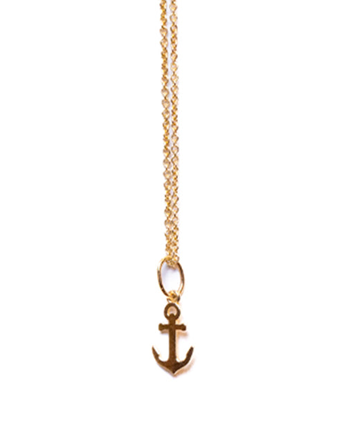 Tiny Anchor charm necklace in pure gold on white background.