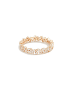 Gold ring with diamonds in front of white background.