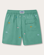 A green pair of shorts with a pocket on the left with orange and blue embroidered suns. 