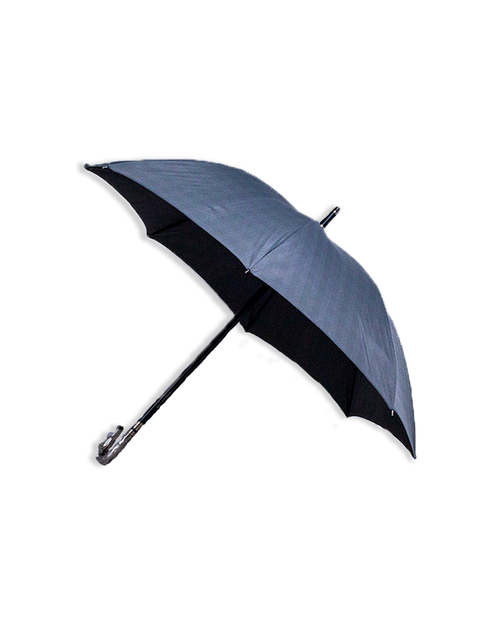 Grey umbrella that is opened and tilted to the side in front of a white background.