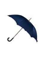 Navy umbrella that is opened and tilted to the side in front of a white background.