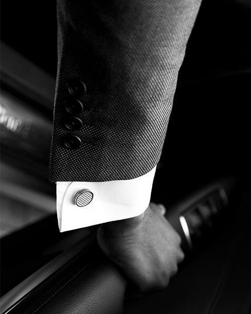 Model arm and wrist showing cufflink. Image in black and white.