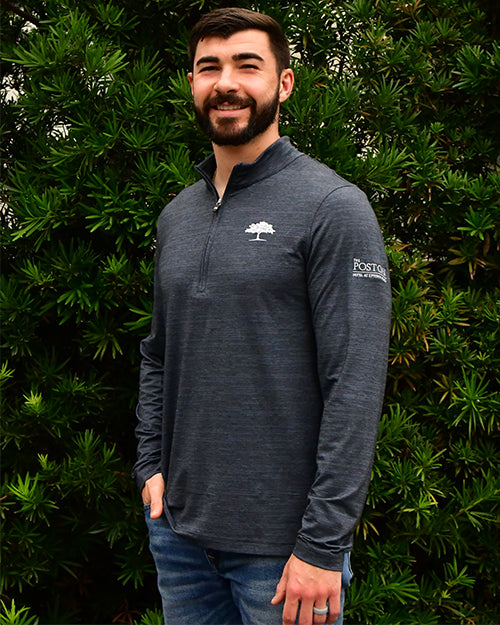 Man wearing Havasu 2.0 Quarter Zip Pullover in front of bush/tree background.