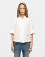 White short-sleeve button-up shirt with pointed collar and relaxed fit

