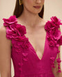 A woman models a pink floral Patbo Chiffon Carmen mini dress, showcasing its vibrant design.