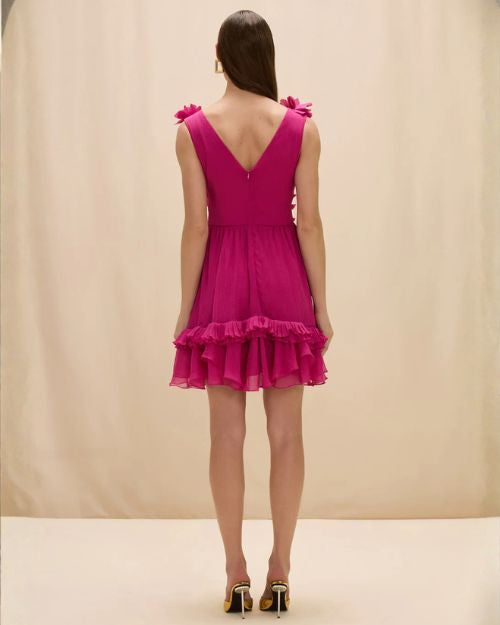 Woman's back in a pink Patbo Chiffon Carmen Flowers mini dress, highlighting the elegant silhouette and delicate chiffon material.
