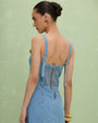 ack view of a woman wearing a PATBO Marina Denim Mini Dress, showcasing its stylish design and denim fabric.