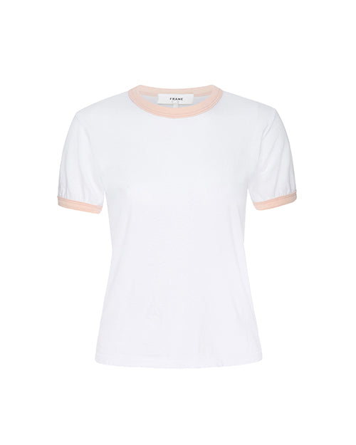 A plain white t-shirt with short sleeves, featuring a ribbed peach-colored crew neckline and matching sleeve hems. The shirt is displayed against a solid white background, emphasizing its clean and simple design. The label at the neck area indicates the brand as ‘FRAME.'
