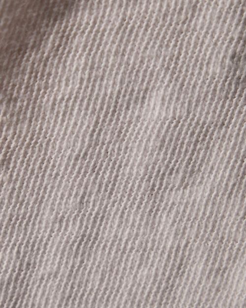 Close-up image of a white cotton long sleeve shirt.