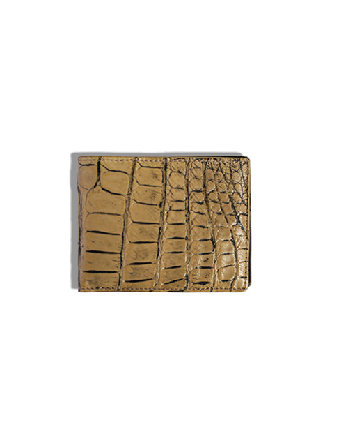 Tan alligator skin wallet in front of white background.