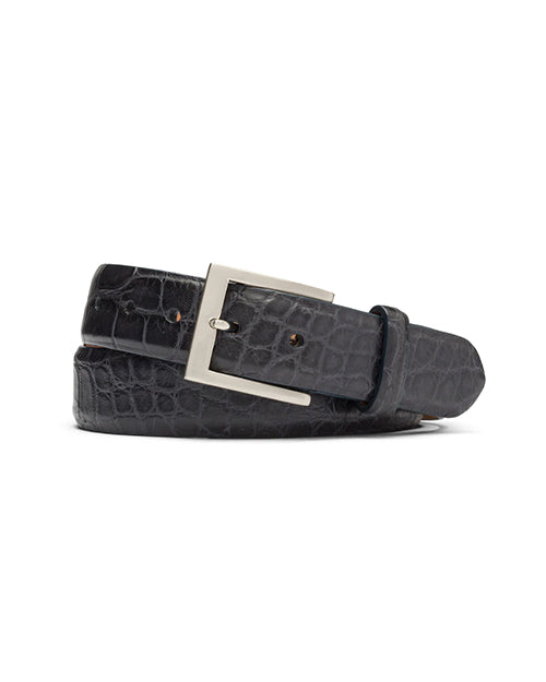 Black alligator belt with silver buckle in front of white background.