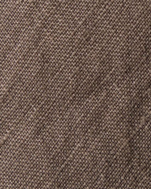 Close-up of a textured fabric showcasing the high-low design of a linen skirt.