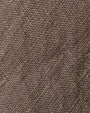 Close-up of a textured fabric showcasing the high-low design of a linen skirt.