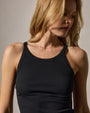 A woman in a black cotton tank top, showcasing a casual and comfortable style.