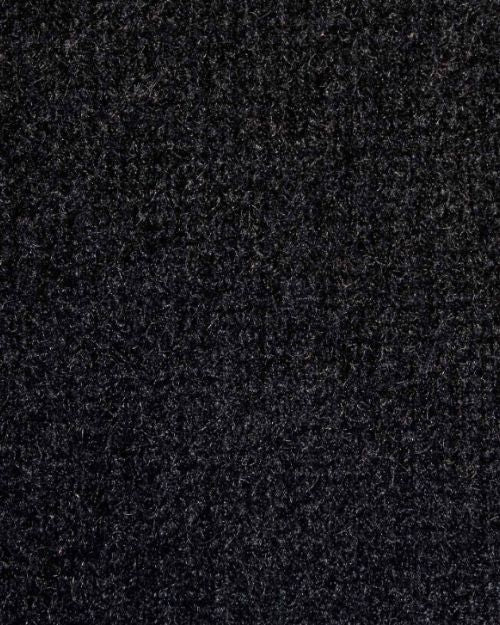 Close-up of a cashmere black track jacket, highlighting the fabric's texture and color.
