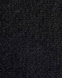 Close-up of a cashmere black track jacket, highlighting the fabric's texture and color.
