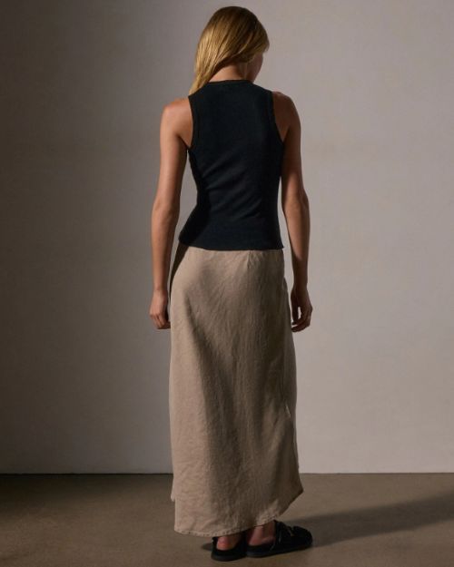 Model wearing a black tank top and long skirt, highlighting the luxurious feel of the cotton cashmere rib material.