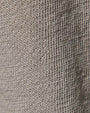 Close-up of a knitted fabric showcasing texture, used in wide-leg sweatpants.