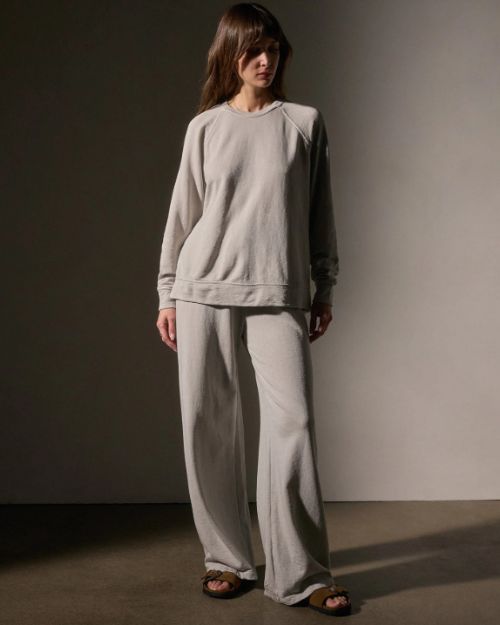 Model wearing a vintage French Terry sweatshirt and wide-legged pants, showcasing a relaxed and stylish look.