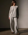 Model wearing a vintage French Terry sweatshirt and wide-legged pants, showcasing a relaxed and stylish look.