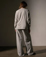A back view of a Model wearing a vintage French Terry sweatshirt and wide-legged pants, showcasing a relaxed and stylish look.