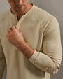 Close-up of a beige waffle-knit long sleeve henley shirt featuring a two-button placket and raglan sleeves