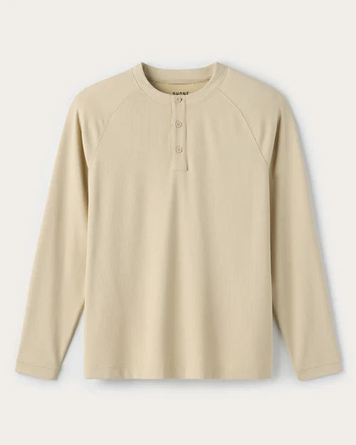 Beige waffle-knit long sleeve henley shirt with a three-button placket and raglan sleeves on a white background