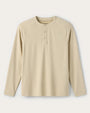 Beige waffle-knit long sleeve henley shirt with a three-button placket and raglan sleeves on a white background