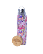 A clear cylindrical travel infuser mug with a floral pattern pink and purple. The mug includes a bamboo lid with a tree silhouette and detachable infuser.