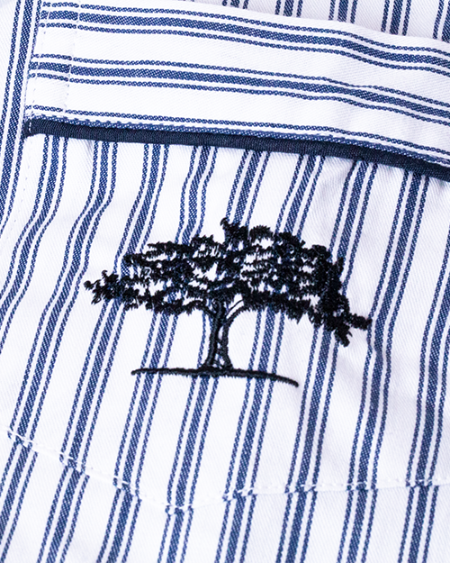 Close up of Post Oak Tree logo stitched in navy on pocket.
