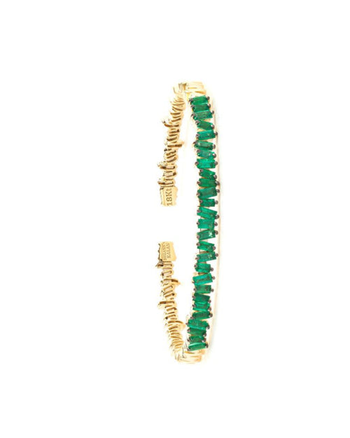 Thin gold bangle bracelet with emeralds.
