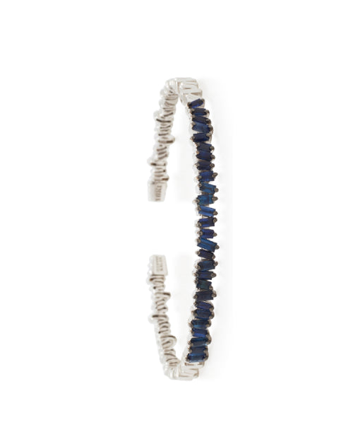 Thin white gold bangle with blue sapphires.