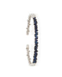Thin white gold bangle with blue sapphires.